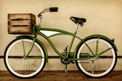 Retro styled sepia image of a vintage beach cruiser bicycle with wooden crate